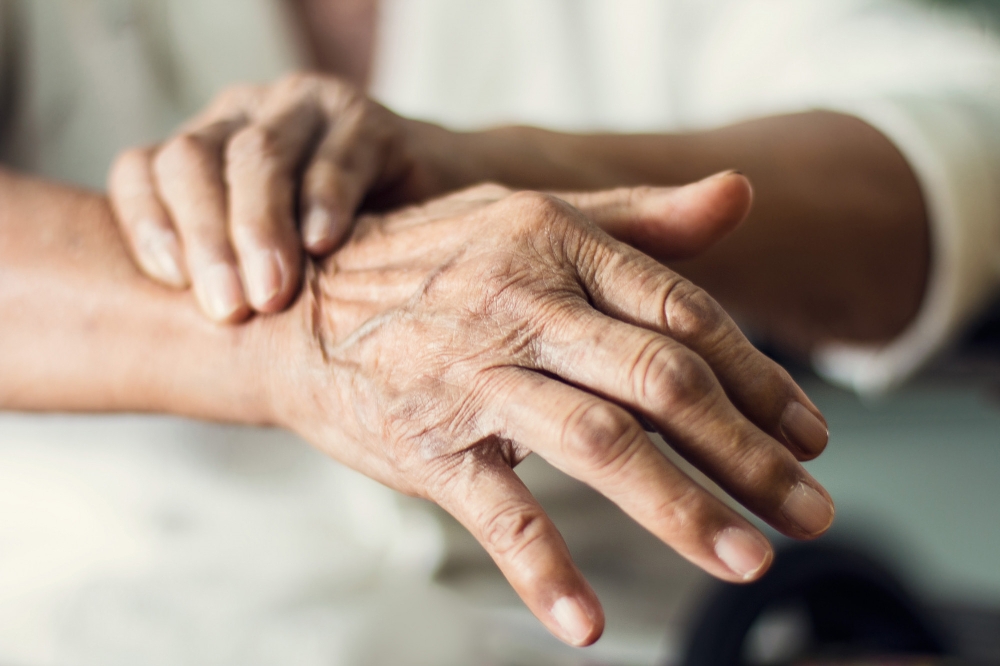 Fingers interlaced and gently stretched together.